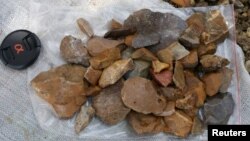 Surface-collected stone artefacts that were found lying scattered on the gravelly surface near Talepu on the Indonesian island of Sulawesi, are pictured in this undated handout photo, Jan. 13, 2016. 