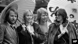 FILE - Members of the Swedish pop group ABBA hold Japanese oil paper parasols in a light rain in the Japanese garden of their hotel in Tokyo, March 14, 1980. From left, they are Benny Andersson, Agnetha Faltskog, Bjorn Ulvaeus and Anni-Frid Lyngstad. 