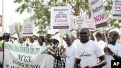 Demonstrators display banners and placards as they participate in a protest in Abuja on March 10, 2010. Around 5,000 Nigerian activists staged a march to demand the sacking of the cabinet and a public appearance by ailing President Umaru Yar'Adua, two wee