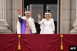FILE - Britain's King Charles III and Britain's Queen Camilla wave from the Buckingham Palace balcony after their coronations on May 6, 2023. (Photo by Oli SCARFF / AFP)