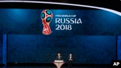 FIFA President Sepp Blatter, right, and Russian President Vladimir Putin open the preliminary draw for the 2018 soccer World Cup in Konstantin Palace in St. Petersburg, Russia, Saturday, July 25, 2015. (AP Photo/Ivan Sekretarev)