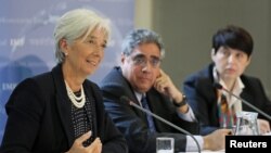 International Monetary Fund managing director Christine Lagarde (L) speaks at a news conference at the Treasury in London, May 22, 2012. 