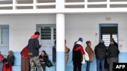 Voters queue outside a polling station during the 2023 local elections in the locality of Mnihla in Ariana province on the outskirts of Tunis on December 24, 2023.