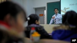 In this Tuesday, Dec. 1, 2009 photo, economist Ilham Tohti speaks to students at the Central Nationalities University in Beijing, China.