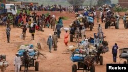 FILE - People fleeing the violence in West Darfur, cross the border into Adre, Chad, August 4, 2023. 