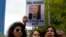 Activists, members of the Human Rights Association Istanbul branch, holding posters with photos of missing Saudi journalist Jamal Khashoggi, talk to members of the media, during a protest in his support near the Saudi Arabia consulate in Istanbul, Turkey, Oct. 9, 2018.