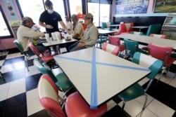 Tables are marked off for social distancing at Hwy 55 Burgers Shakes & Fries, April 27, 2020, in Nolensville, Tennessee.