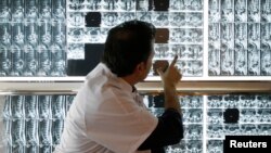 FILE - A radiologist examines X-rays of a patient at a hospital in Marseille, southern France, April 8, 2008. 