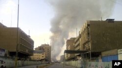 Smoke rises from the site of bomb attacks targeted Baghdad's wholesale Shurja market, Iraq, November 6, 2011.