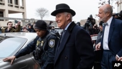 FILE - Roger Stone, center, departs federal court in Washington, Feb. 20, 2020. 