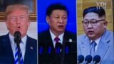 People watch a screen showing images of (L-R) South Korea's president Moon Jae-in, US president Donald Trump, China's president Xi Jinping, and North Korea's leader Kim Jong Un at a railway station in Seoul on May 11, 2018.