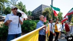 FILE - Iranian Americans opposed to Iran's Islamist rulers protest in front of the Comfort Inn Sandy Springs - Perimeter hotel, which Iran used as a polling station for its citizens who wanted to vote in its presidential election, June 18, 2021.