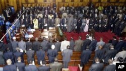 Kenya's politicians gather for the tenth parliament opening, Tuesday, Jan. 15, 2008, Nairobi, the opposition, facing the camera and the government members of parliament with their backs to camera, President Mwai Kibaki is on the left