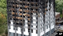 FILE - The burnt Grenfell Tower apartment building standing testament to the recent fire in London, June 23, 2017.