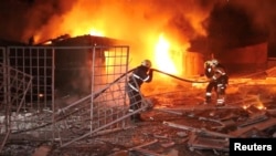Emergency personnel work to put out a fire following a drone attack, amid Russia's attack on Ukraine, in Kharkiv, Ukraine in this screengrab obtained from a video released on Jan. 31, 2024.