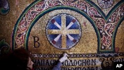 A restoration expert works on a mosaic inside the Church of the Nativity, in the West Bank city of Bethlehem, Feb. 4, 2016.