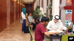 FILE - In this 2011 photo, students of different nationalities study at the Texas A&M University campus at Education City in Doha, Qatar. 