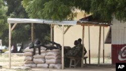 Nigerian troops man a checkpoint to prevent sectarian violence.