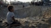 Palestinians look at the destruction after an Israeli airstrike on a crowded tent camp housing Palestinians displaced by the war in Muwasi, Gaza Strip, Sept. 10, 2024. 