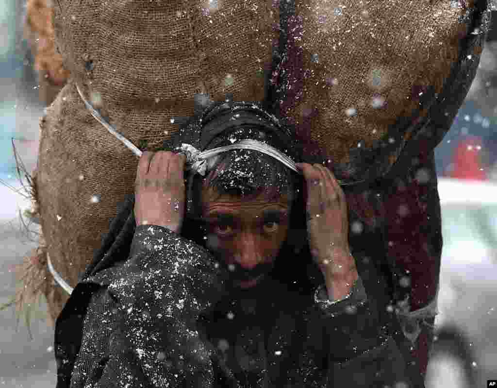 A man carries sacks of charcoal in Srinagar, Indian controlled Kashmir.