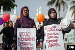Para ibu memprotes pelecehan seksual anak di Banda Aceh di provinsi Aceh, di pulau Sumatera bagian barat, 24 April 2014, menyusul insiden pelecehan seksual anak di Banda Aceh dan di Jakarta. (Foto: AFP)