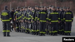 Members of a Disaster Response Unit from the Romanian Emergency Services prepare to depart from the Romanian Air Force 90th Airlift Base, in order to assist Turkish Emergency Services following the earthquake in Turkey, in Otopeni, Romania, Feb. 6, 2023. Inquam Photos/George Calin via REUTERS