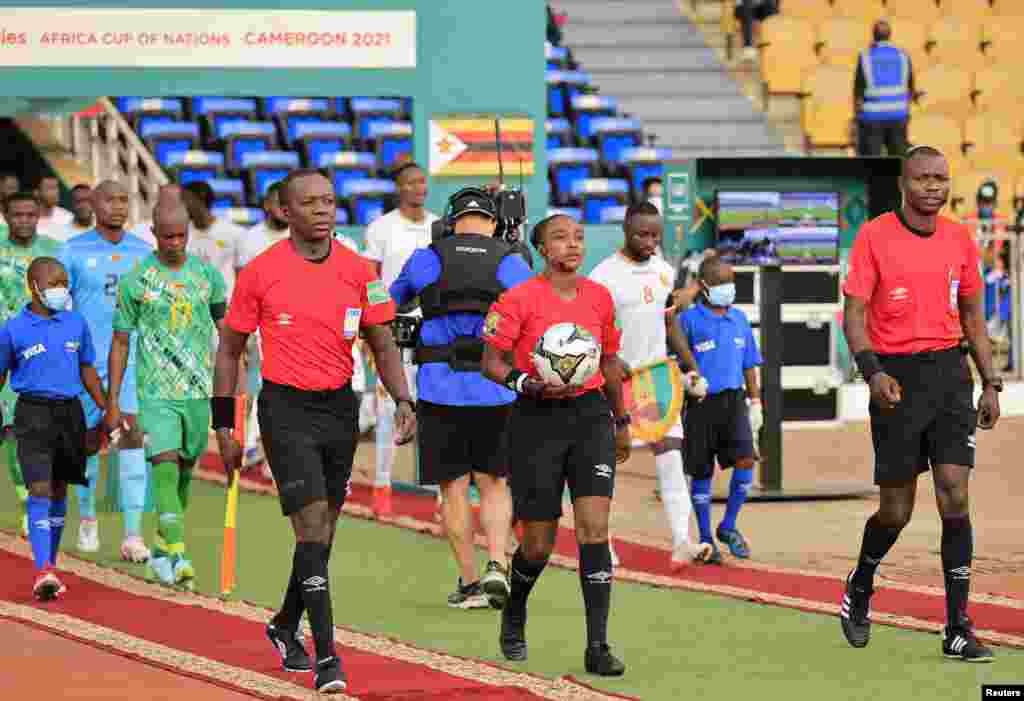 Referee Salima Mukansanga with assistant referee&#39;s Lahsen Azgaou and Oliver Kabene Safari before the match Zimbabwe vs Guinea; Cameroon, Jan. 18, 2022