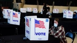 A voter completes his ballot at a poling place inside Bankers Life Fieldhouse on Election Day in Indianapolis, Indiana, Nov. 3, 2020.