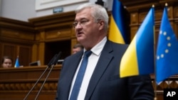 In this photo provided by the Ukrainian Parliament Press Office, Ukraine's newly appointed Foreign Minister Andrii Sybiha speaks in parliament in Kyiv, Ukraine, Sept. 5, 2024.