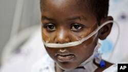 FILE - Five-year-old Haitian boy Woodley Elyse sits on his bed after heart surgery, at the Wolfson Medical center in Holon, near Tel Aviv, Israel, Tuesday, March 2, 2010.