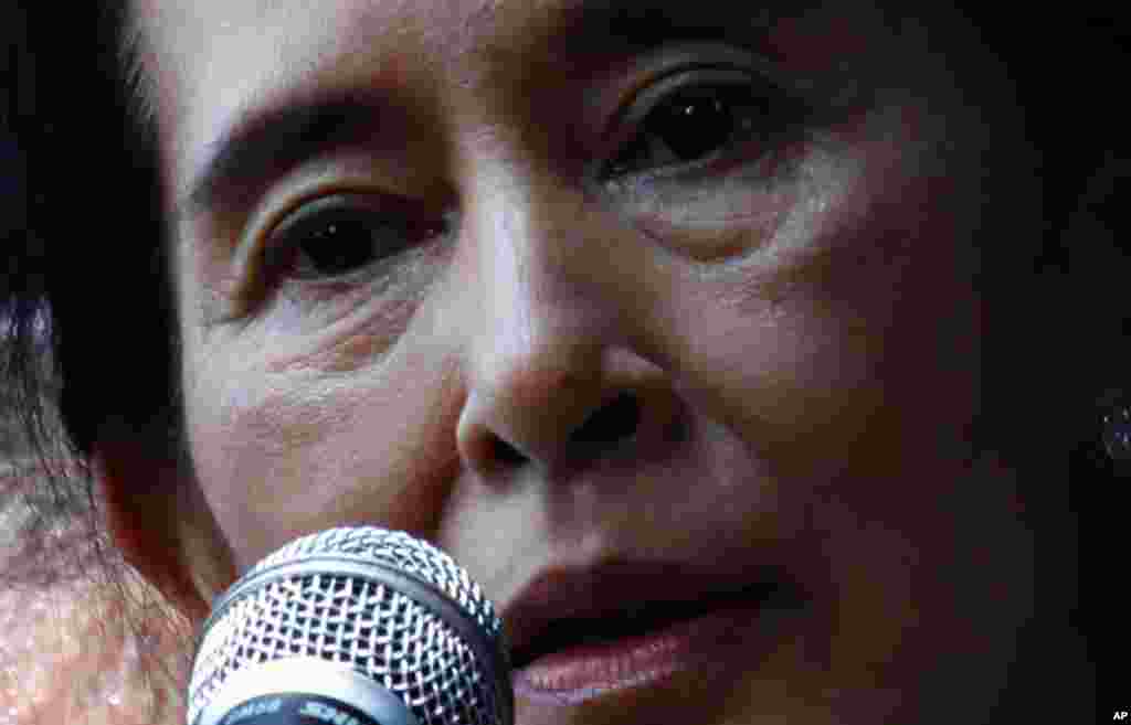 November 14: Aung San Suu Kyi addresses supporters outside the headquarters of her National League for Democracy party in Yangon. The pro-democracy leader called for freedom of speech in army-ruled Myanmar on Sunday and urged thousands of supporters to st