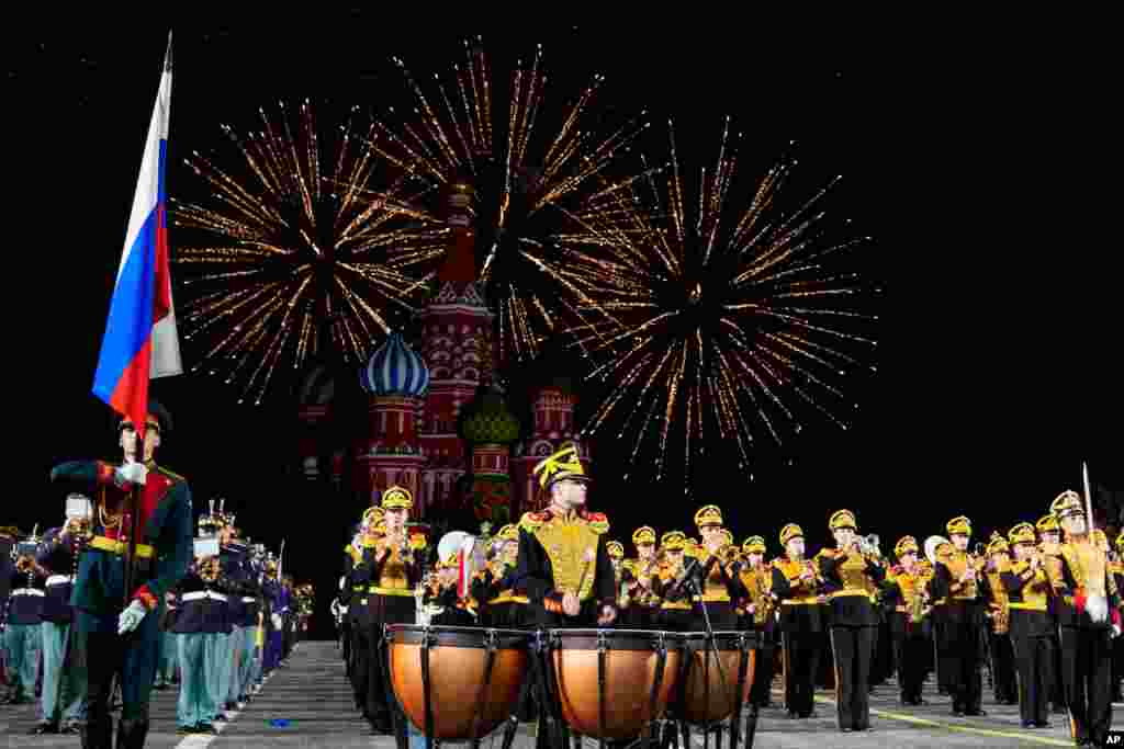 Fireworks explode as a combined military band of the participating countries performs during the Spasskaya Tower International Military Music Festival in Red Square, with the St. Basil Cathedral in the background, in Moscow, Russia,  Aug. 31, 2021