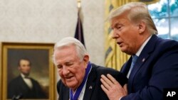 President Donald Trump presents the Presidential Medal of Freedom to former Attorney General Edwin Meese, in the Oval Office of the White House, Oct. 8, 2019.