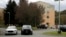 FILE - Police cruisers are parked near the entrance of the Wanaque Center for Nursing And Rehabilitation in Haskell, N.J., where New Jersey health officials have confirmed 28 cases of adenovirus as of Nov. 1, 2018. 