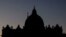 FILE - Saint Peter's Basilica is silhouetted against the sky at the Vatican, Dec. 16, 2023.