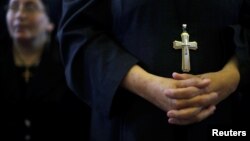Coptic Egyptians pray in al-Our village south of Cairo, Egypt, May 15, 2018. A defrocked monk has been detained in the death of Bishop Epiphanius, abbot of St. Macarius Monastery, a prominent monastery in the desert northwest of Cairo.