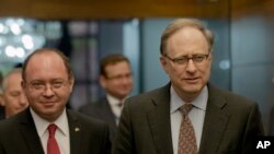 FILE - Romanian Foreign Minister Bogdan Aurescu, left, walks with NATO Deputy Secretary-General Alexander Vershbow in Bucharest, Romania, Oct. 15, 2015.