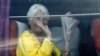 A passenger waves from a bus after she disembarked from the MS Westerdam, owned by Holland America Line, at the port of Sihanoukville, Cambodia, Friday, Feb. 14, 2020. Passengers finally disembarked on Friday from the cruise ship allowed to dock in…