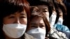 People wearing face masks stand in line to buy masks at a post office amid the rise in confirmed cases of coronavirus disease (COVID-19) in Daegu, South Korea, March 5, 2020. 