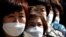 People wearing face masks stand in line to buy masks at a post office amid the rise in confirmed cases of coronavirus disease (COVID-19) in Daegu, South Korea, March 5, 2020. 