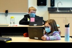 FILE - Students wear masks as they work in a fourth-grade classroom at Elk Ridge Elementary School in Buckley, Wash., Feb. 2, 2021.