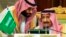 FILE - In this Dec. 9, 2018 file photo, released by the state-run Saudi Press Agency, Saudi Crown Prince Mohammed bin Salman, left, speaks to his father, King Salman, at a meeting of the Gulf Cooperation Council in Riyadh, Saudi Arabia.