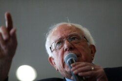 FILE - Presidential candidate Sen. Bernie Sanders addresses airline food workers and representatives from UNITE HERE during a rally for better wages and health insurance coverage at Reagan National Airport in Arlington, Va., July 23, 2019.