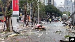 This image taken from video by Taiwan's TVBS shows the debris strewn across the streets in the aftermath of an explosion at the Shin Kong Mitsukoshi department store in Taichung city in Taiwan on Feb. 13, 2025.