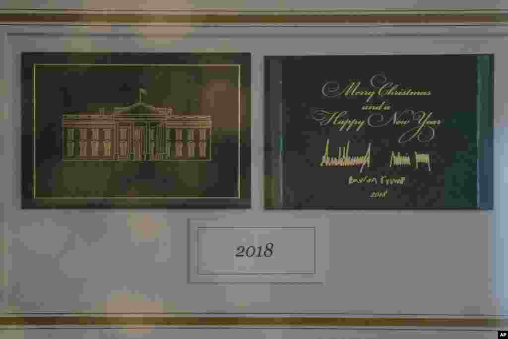 The First Family's holiday card is seen behind glass in Booksellers during the 2018 Christmas preview at the White House in Washington, Monday, Nov. 26, 2018. (AP Photo/Carolyn Kaster) 