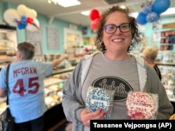 Bakery owner Kathleen Lochel holds sugar cookies at Lochel Bakery on Tuesday, Sept. 24, 2024, in Hatboro, a suburb of Philadelphia. (AP Photo/Tassanee Vejpongsa)