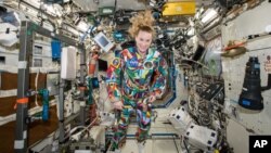 An undated handout photo from NASA shows astronaut Kate Rubins aboard the International Space Station wearing a hand-painted spacesuit decorated by childhood cancer patients at the University of Texas MD Anderson Cancer Center in Houston.