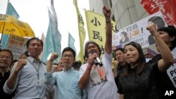 FILE - Pro-democracy Hong Kong lawmakers of the legislature council, Edward Yiu, Nathan Law, Leung Kwok-hung and Lau Siu-lai protest outside the High Court in Hong Kong, July 14, 2017.