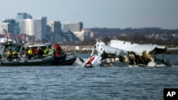 In this image provided by the US Coast Guard, wreckage is seen in the Potomac River near Ronald Reagan Washington National Airport, Jan. 30, 2025, in Washington. 