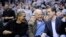 President Barack Obama talks with Vice President Joe Biden, center, and his son Hunter Biden, right, at the Duke Georgetown NCAA college basketball game, Jan. 30, 2010, in Washington. 